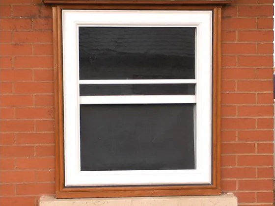 Storm window fitted outside an older window, with the original sash behind it